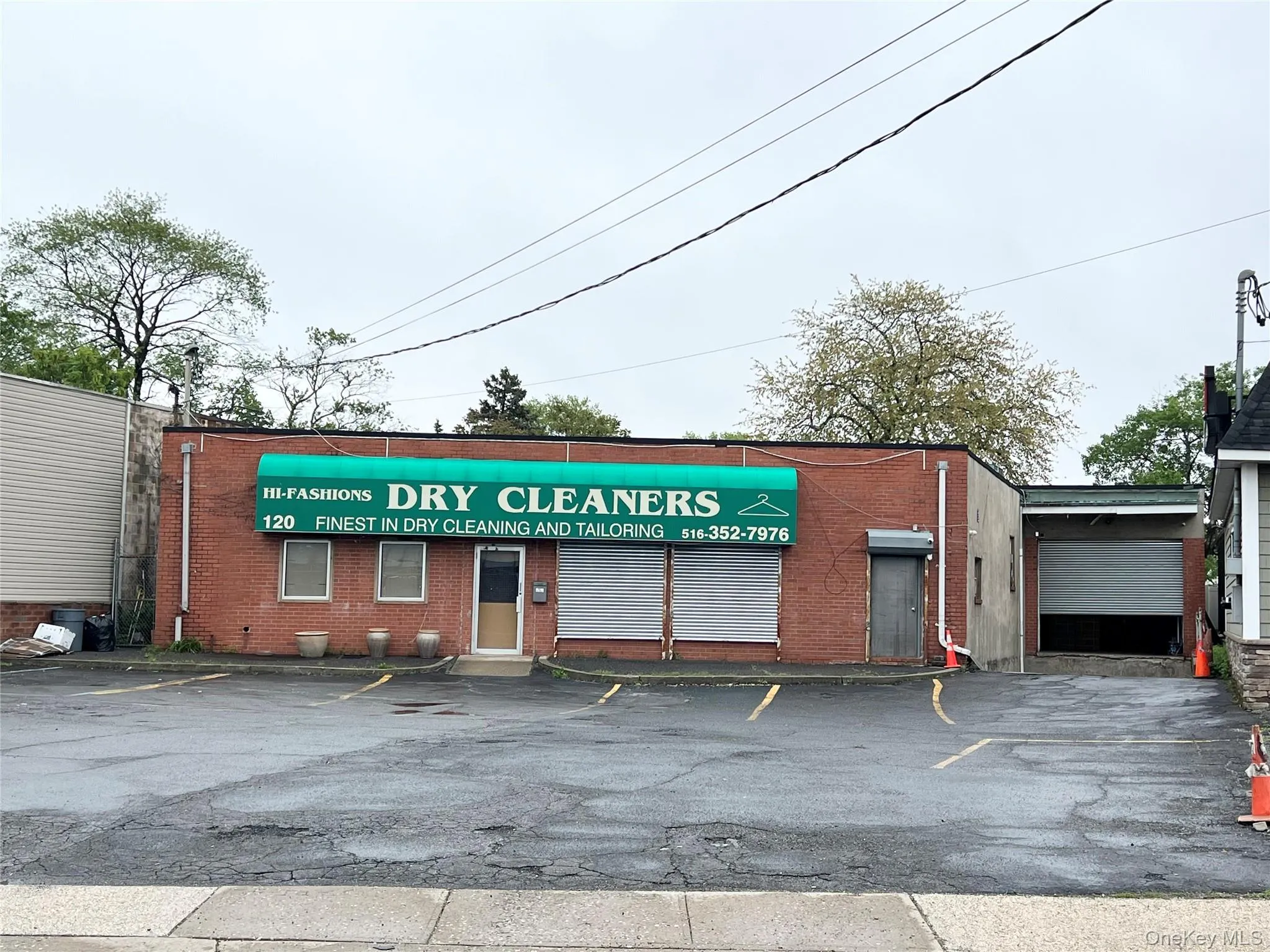 View of commercial property with uncovered parking View of commercial property with uncovered parking