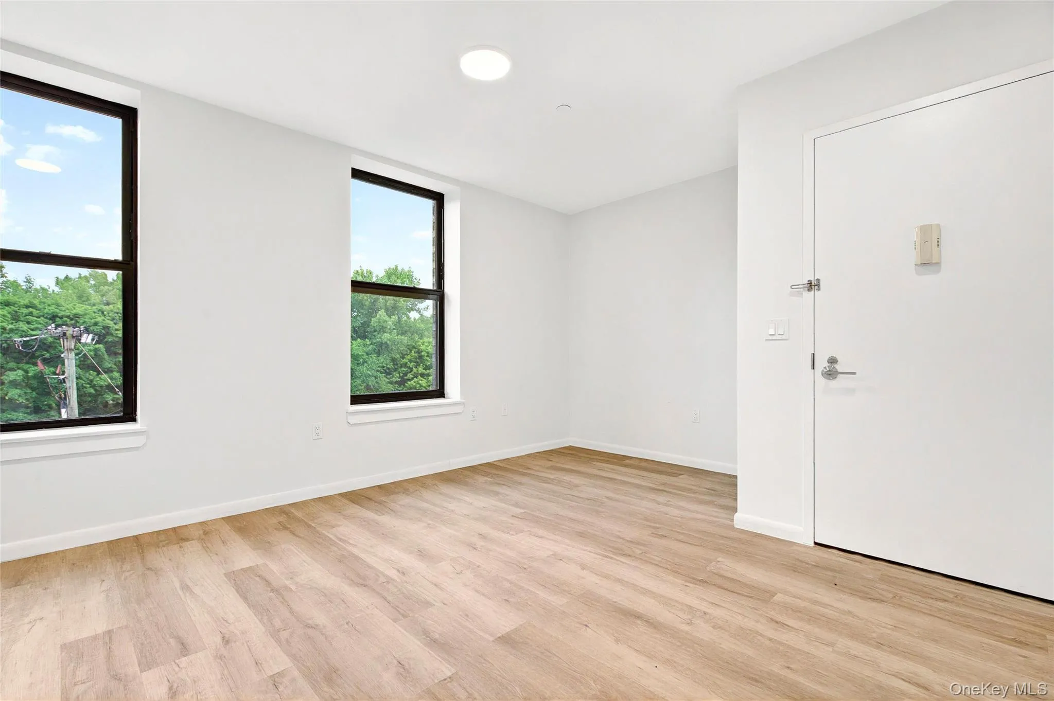 Front living area showing large windows and entrance Front living area showing large windows and entrance