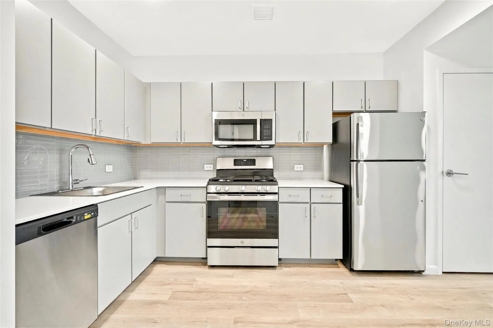 Kitchen showing stainless steel refrigerator, stove, microwave and dishwasher Kitchen showing stainless steel refrigerator, stove, microwave and dishwasher