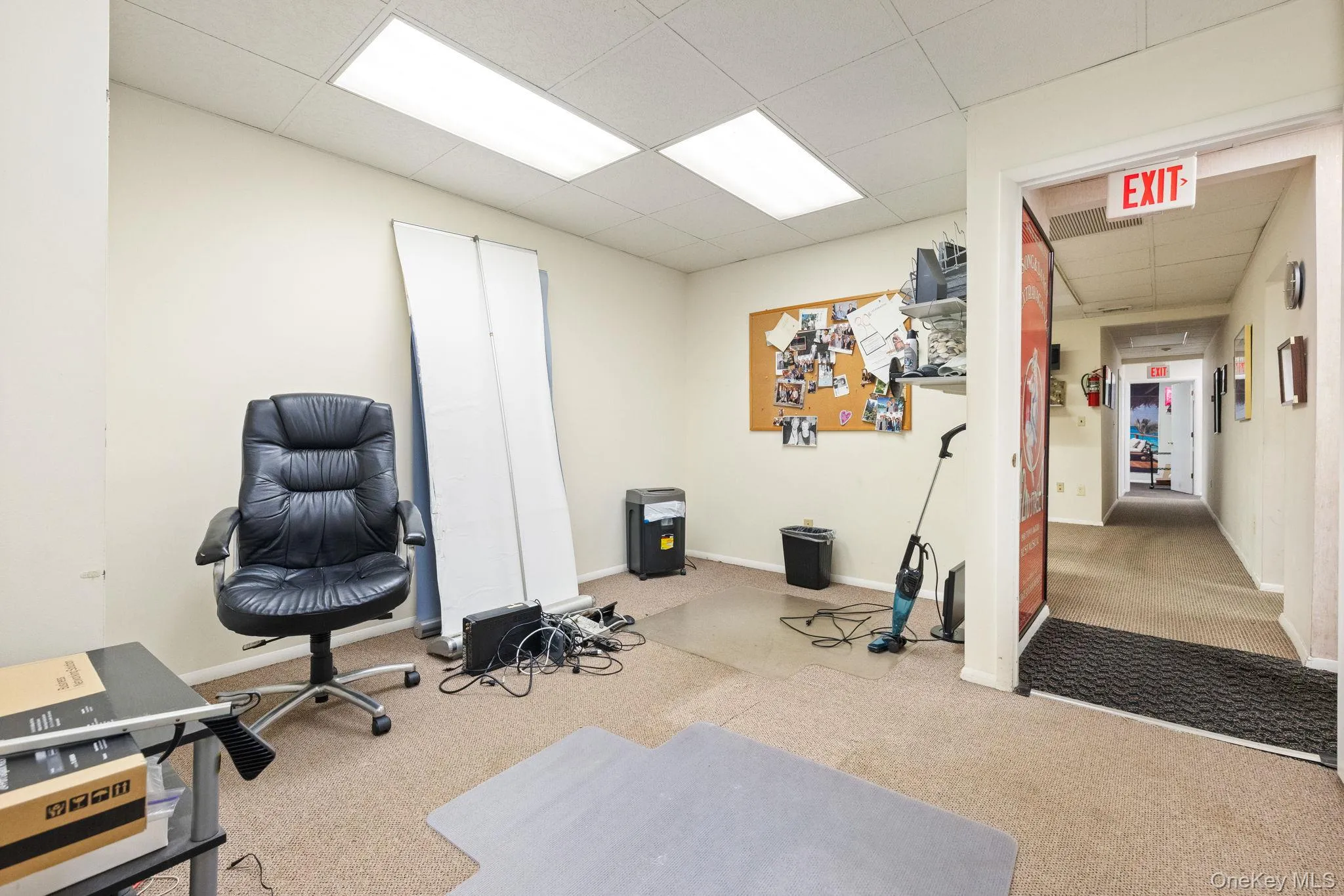 Office with a drop ceiling and carpet floors Office with a drop ceiling and carpet floors