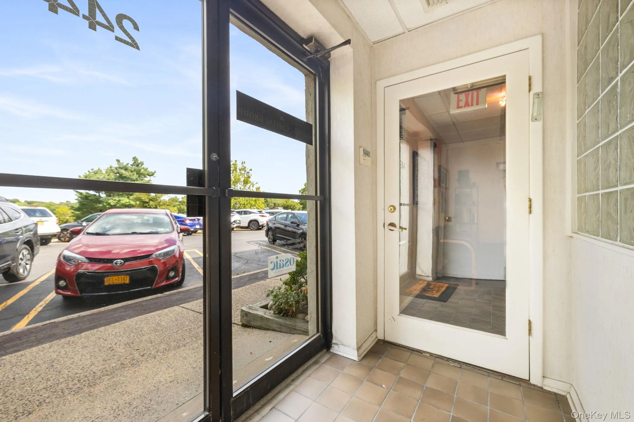 Doorway to outside with tile patterned flooring and baseboards Doorway to outside with tile patterned flooring and baseboards