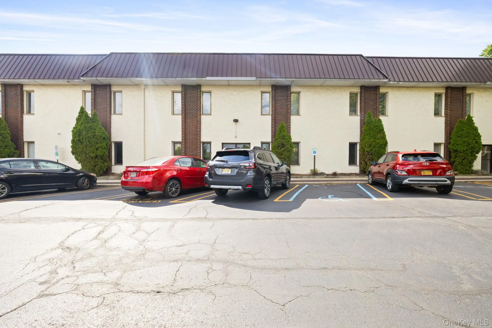 View of property with uncovered parking View of property with uncovered parking