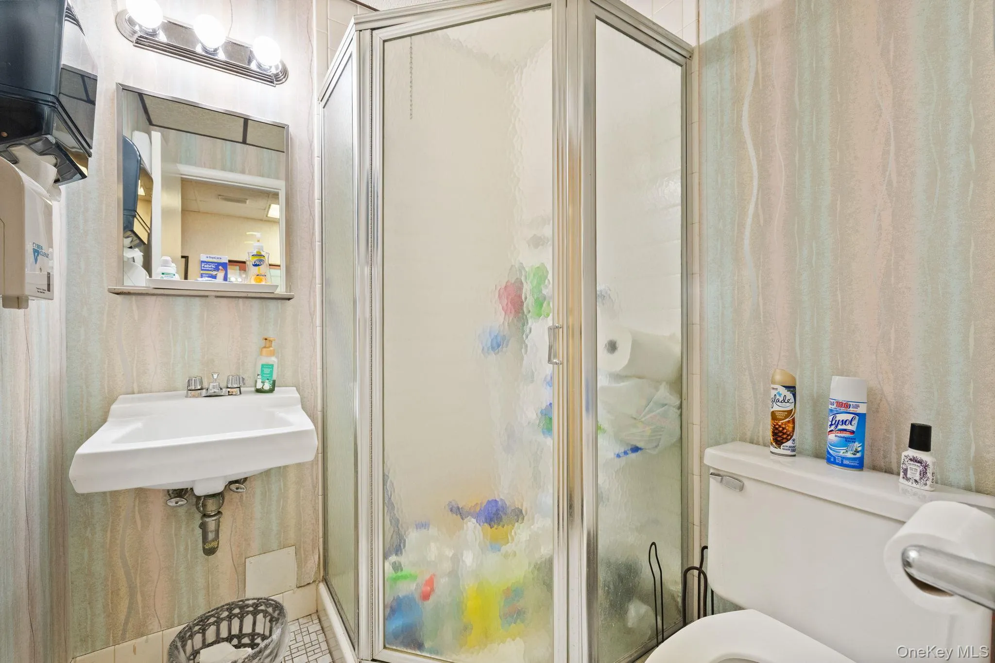 Full bath featuring a stall shower and toilet Full bath featuring a stall shower and toilet