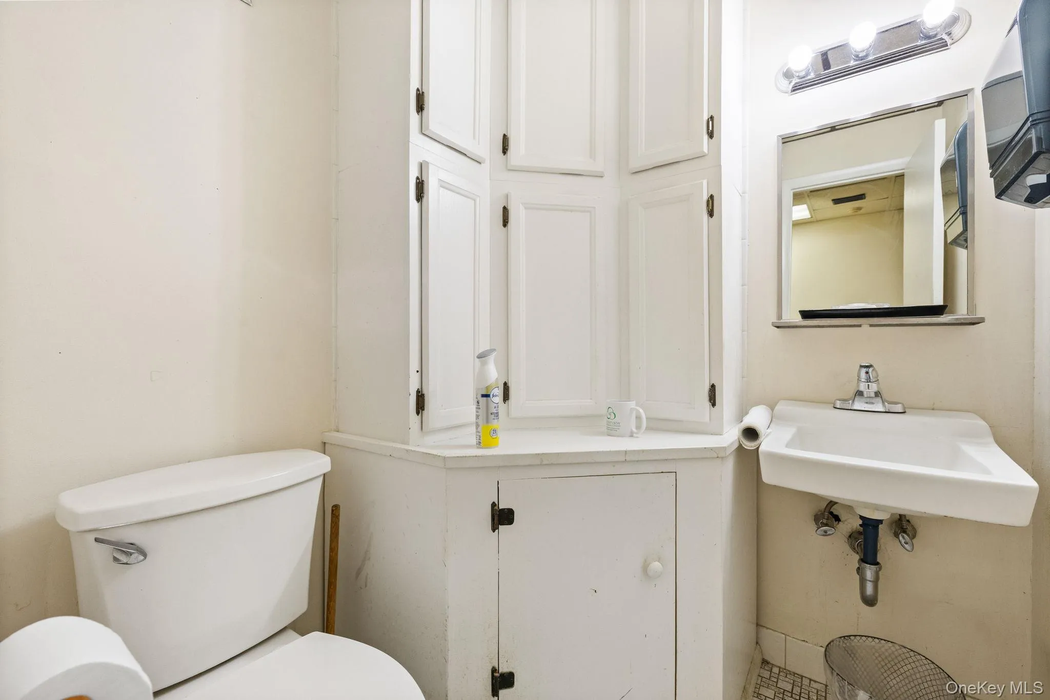 Bathroom featuring toilet and a sink Bathroom featuring toilet and a sink