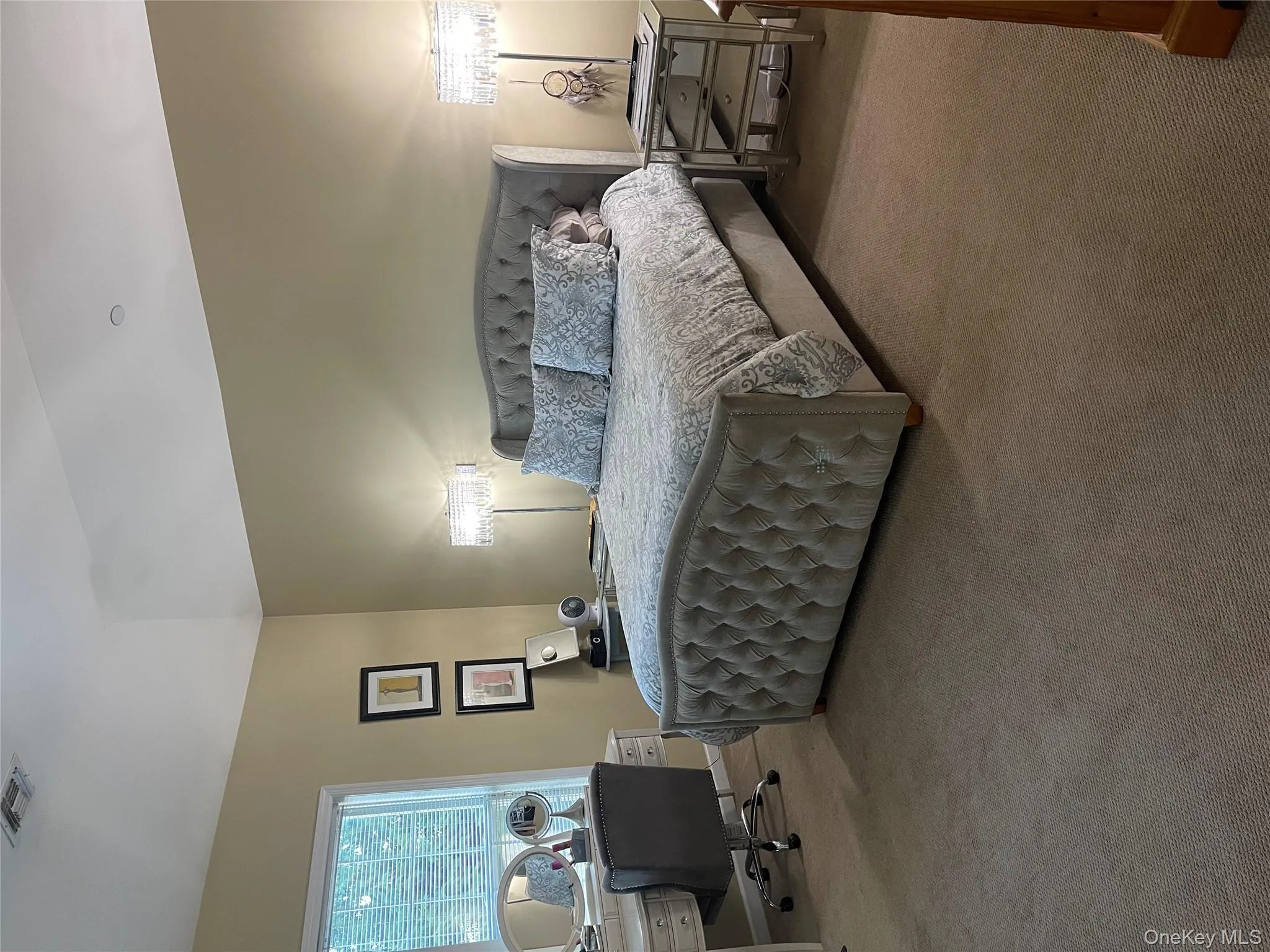 Carpeted bedroom with an office area and lofted ceiling Carpeted bedroom with an office area and lofted ceiling