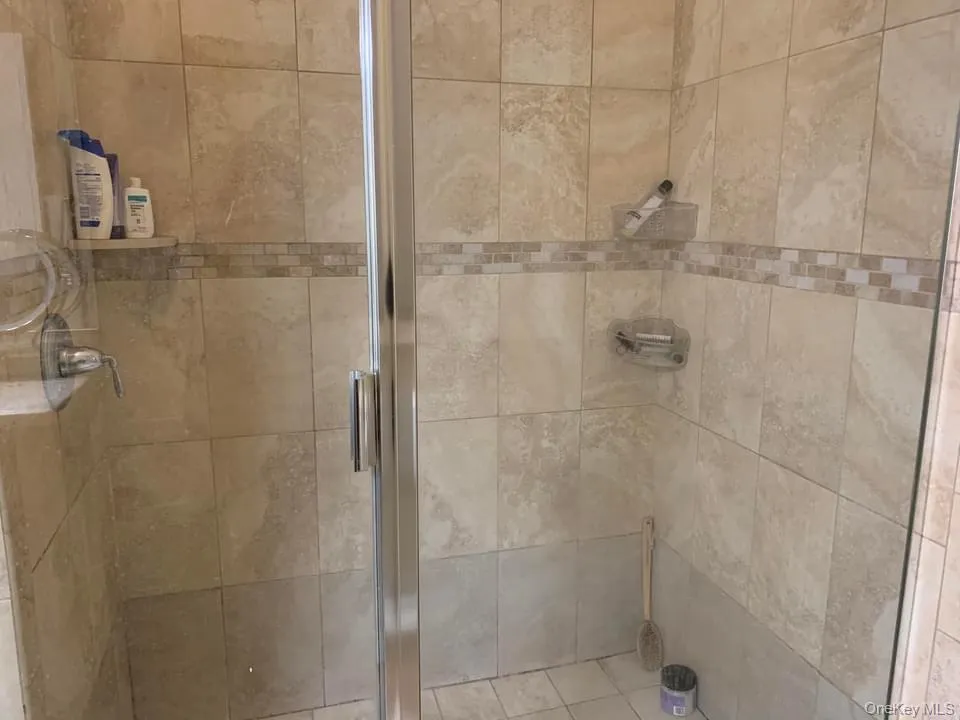 Bathroom featuring a stall shower Bathroom featuring a stall shower