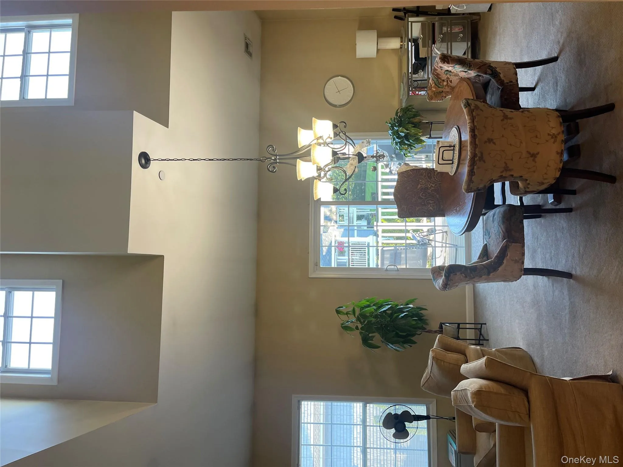 Dining room with healthy amount of natural light, carpet flooring, and a chandelier Dining room with healthy amount of natural light, carpet flooring, and a chandelier