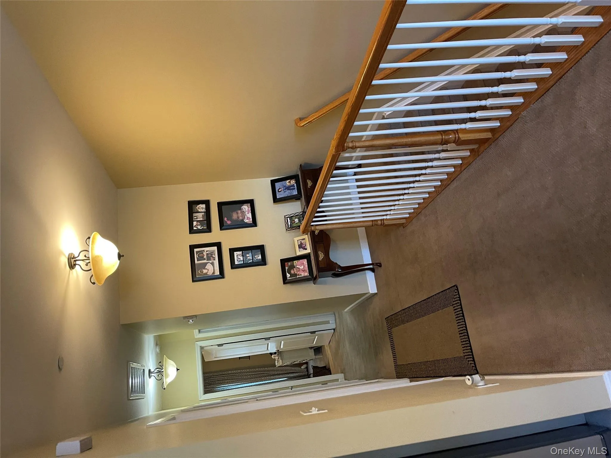 Hall featuring an upstairs landing and carpet Hall featuring an upstairs landing and carpet