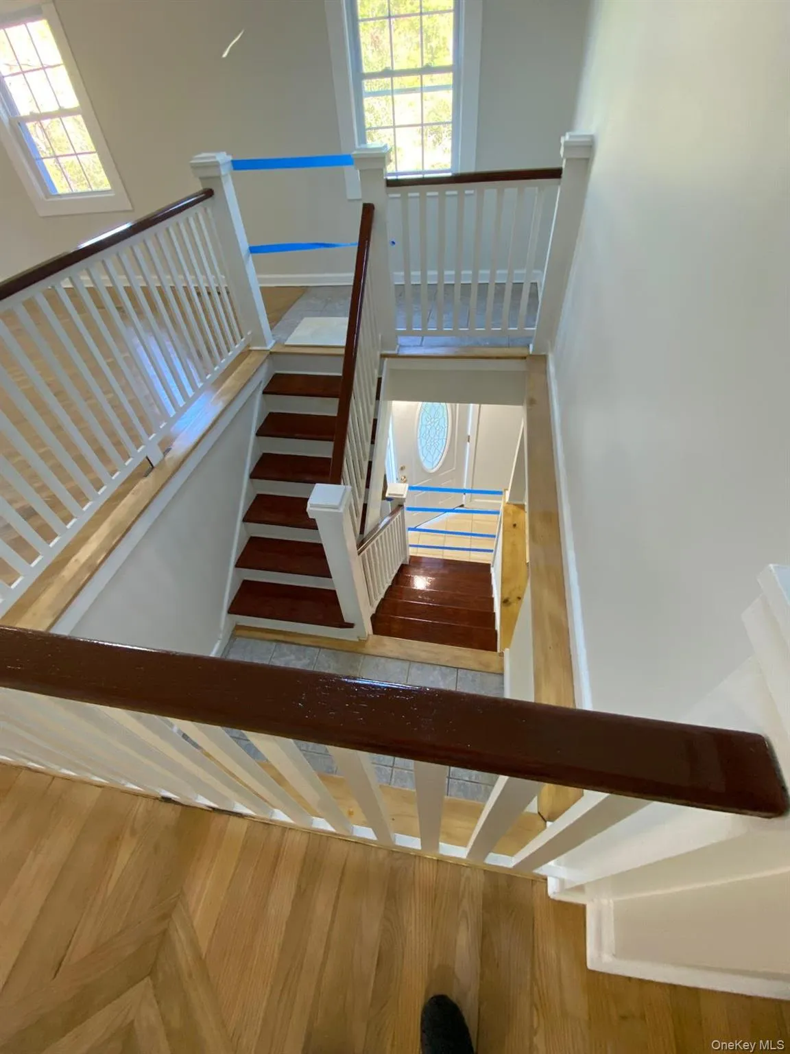 Stairway featuring baseboards and wood finished floors Stairway featuring baseboards and wood finished floors