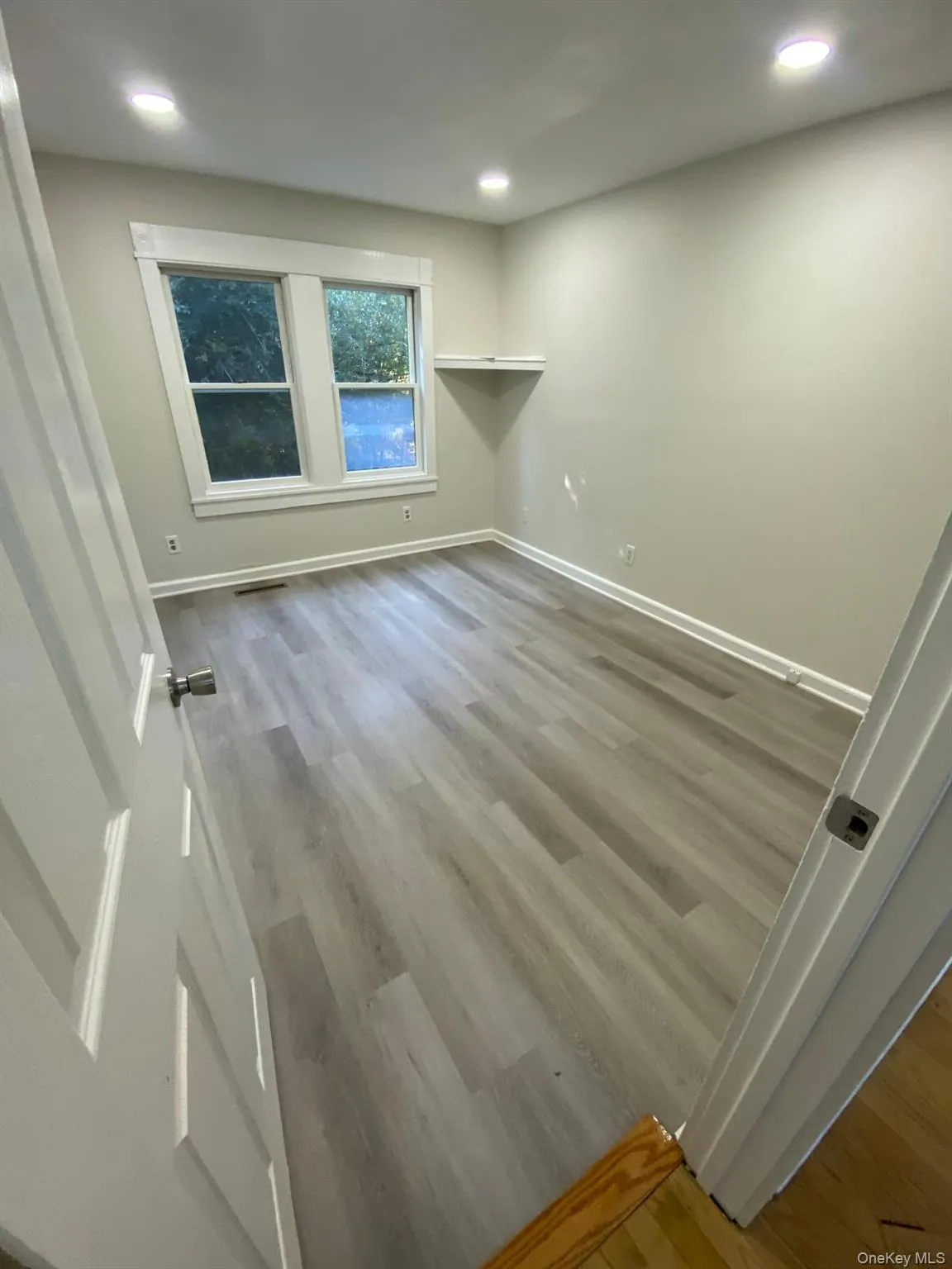 Spare room with wood finished floors and recessed lighting Spare room with wood finished floors and recessed lighting
