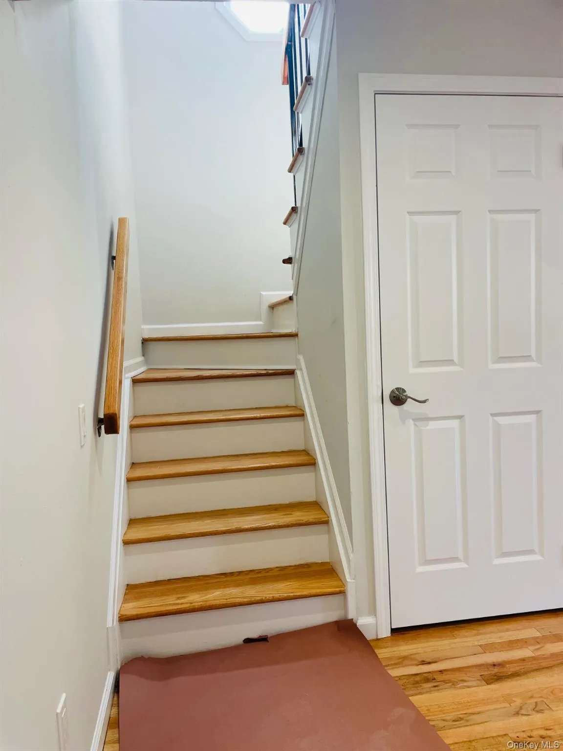 Staircase featuring wood finished floors and baseboards Staircase featuring wood finished floors and baseboards