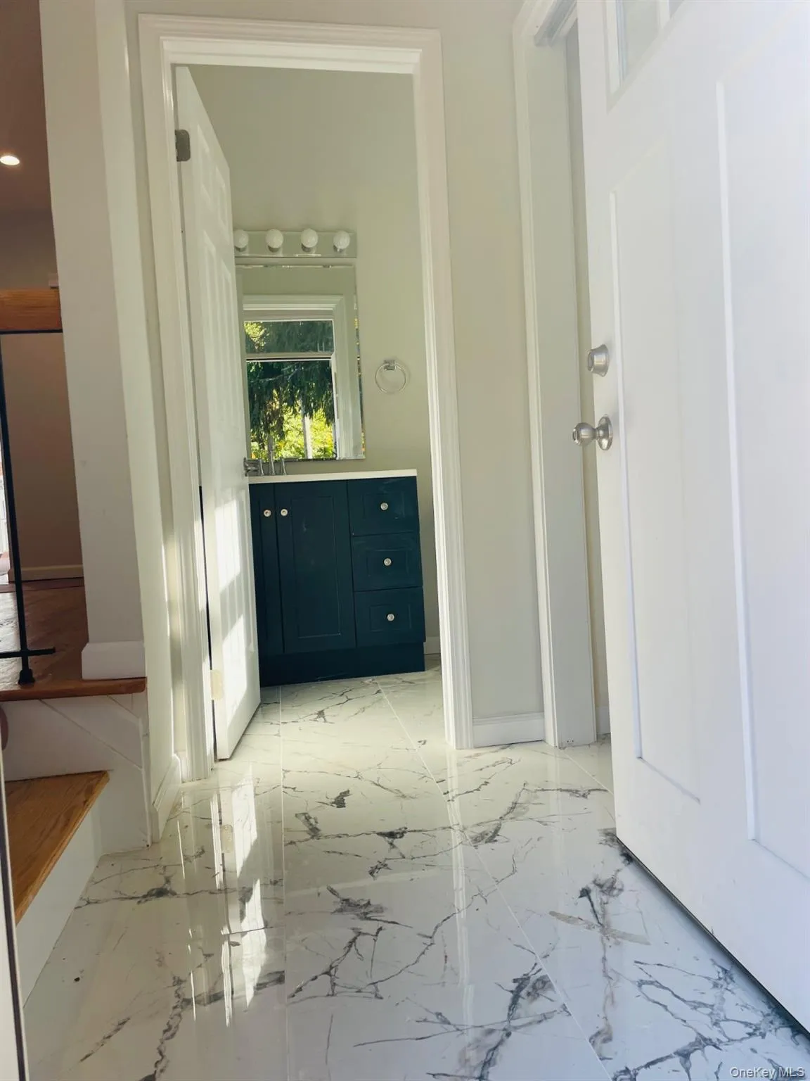 Bathroom with light marble finish flooring and vanity Bathroom with light marble finish flooring and vanity