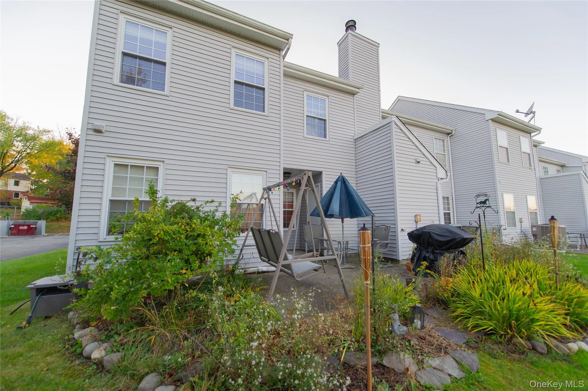 Back of property featuring a patio area and a chimney Back of property featuring a patio area and a chimney
