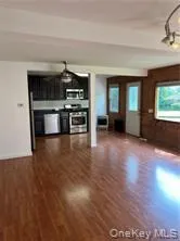 Unfurnished living room with dark wood finished floors Unfurnished living room with dark wood finished floors