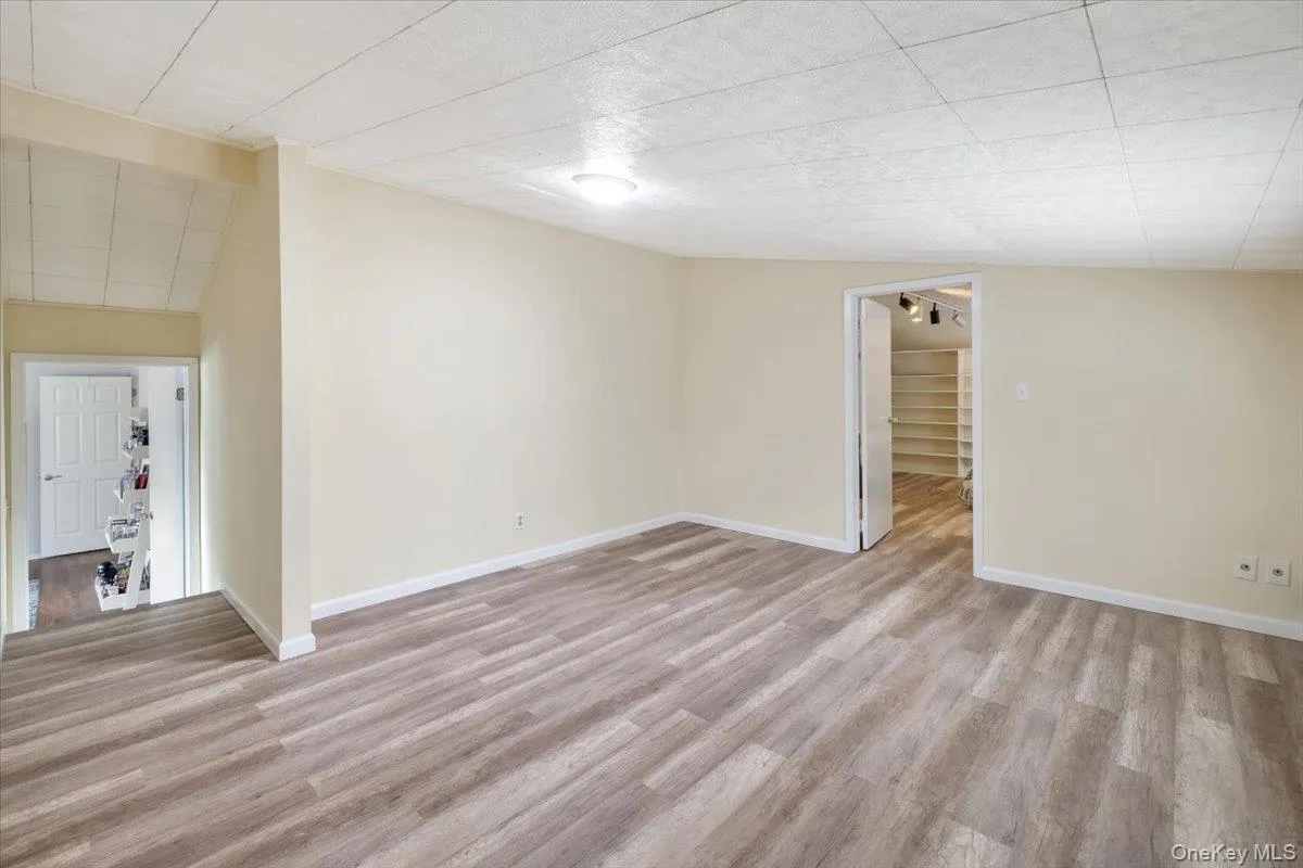 Empty room featuring light wood finished floors and baseboards Empty room featuring light wood finished floors and baseboards