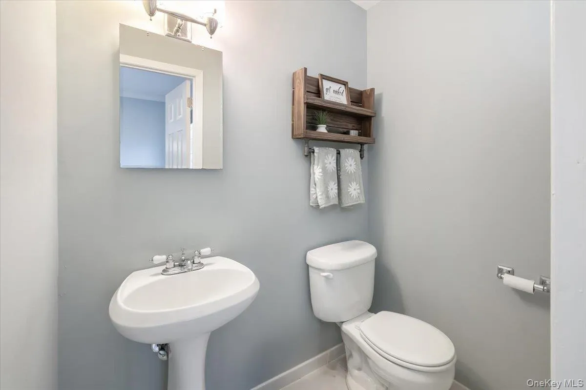 Half bath with baseboards and toilet Half bath with baseboards and toilet