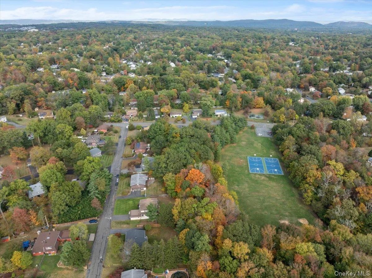 Aerial overview of property's location featuring a forest Aerial overview of property's location featuring a forest