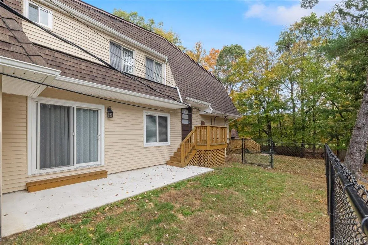 View of yard featuring a patio, a gate, stairs, and a balcony View of yard featuring a patio, a gate, stairs, and a balcony