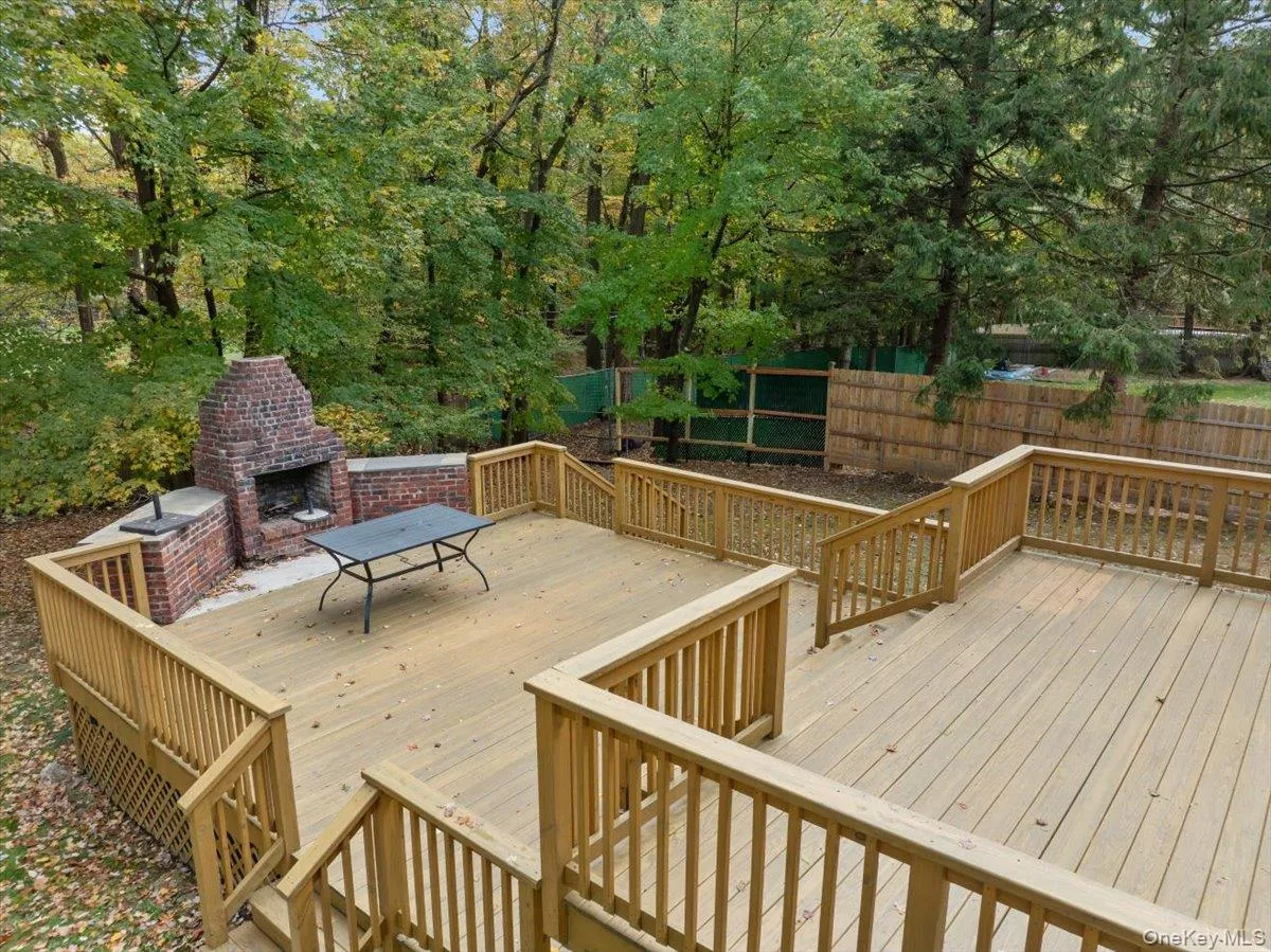 Wooden terrace with an outdoor brick fireplace Wooden terrace with an outdoor brick fireplace