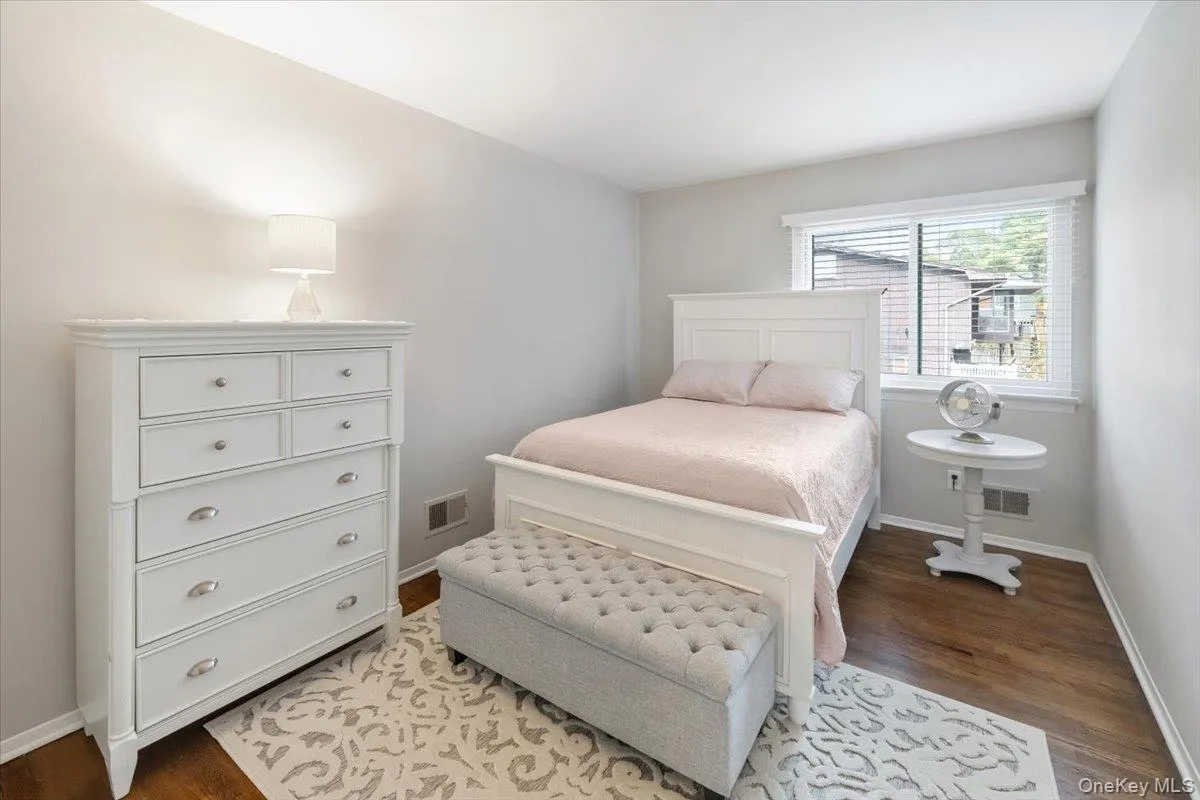 Bedroom featuring baseboards and dark wood finished floors Bedroom featuring baseboards and dark wood finished floors