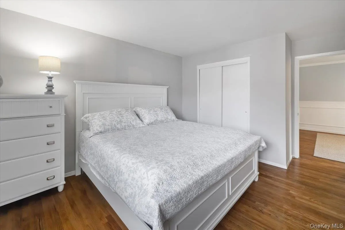 Bedroom with a closet and dark wood finished floors Bedroom with a closet and dark wood finished floors