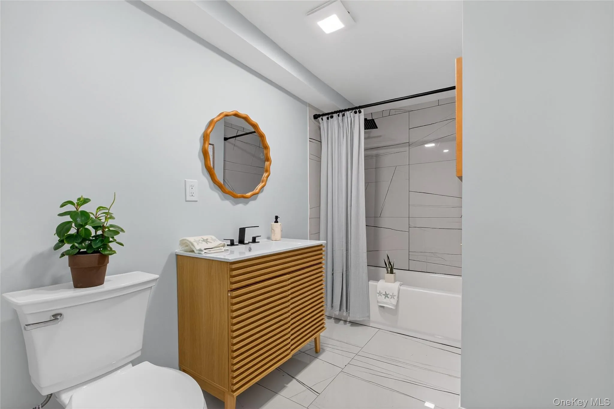 Bathroom with shower / bathtub combination with curtain and vanity Bathroom with shower / bathtub combination with curtain and vanity