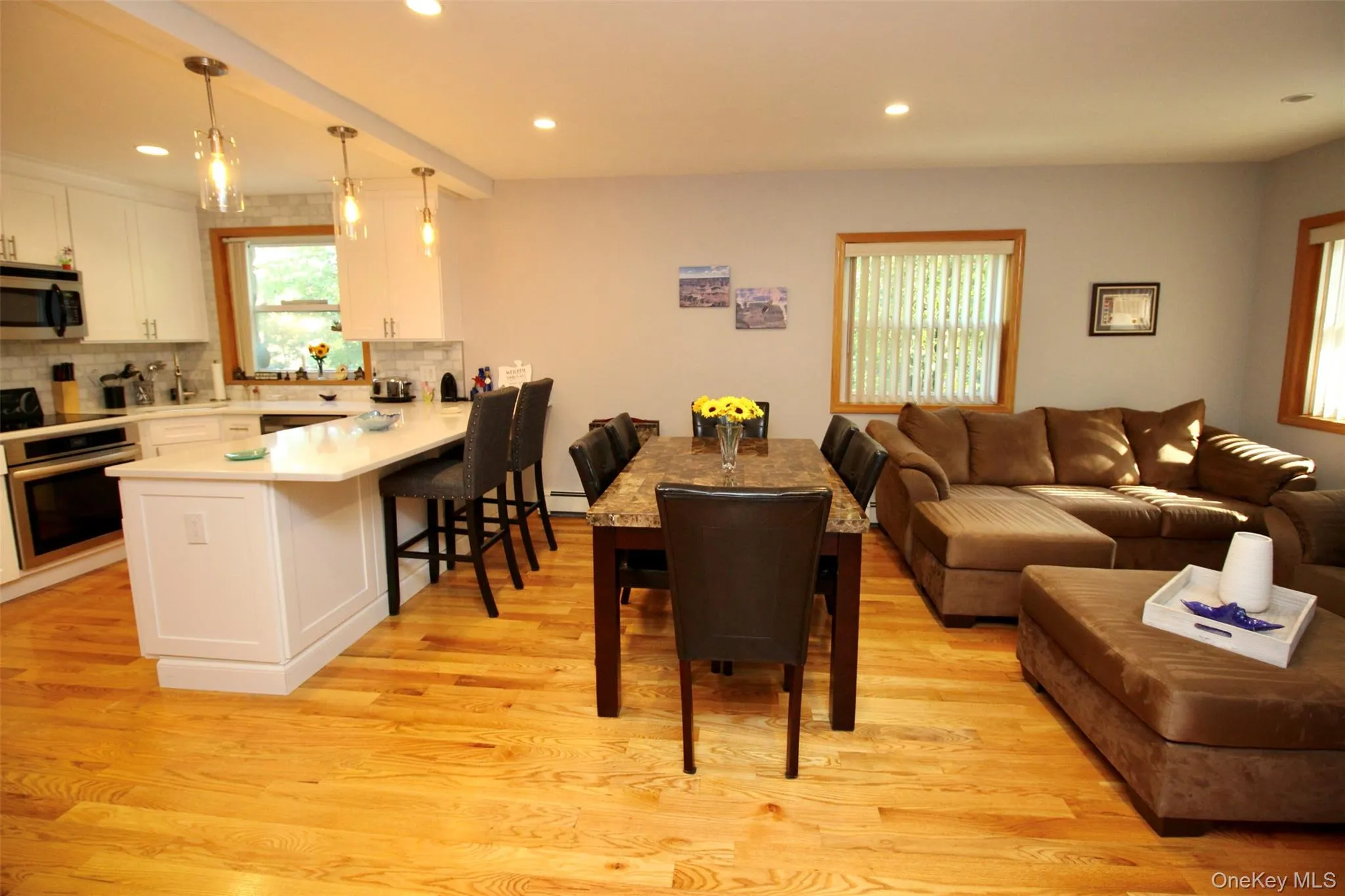 Living area featuring light wood-style floors, recessed lighting, and beam ceiling Living area featuring light wood-style floors, recessed lighting, and beam ceiling