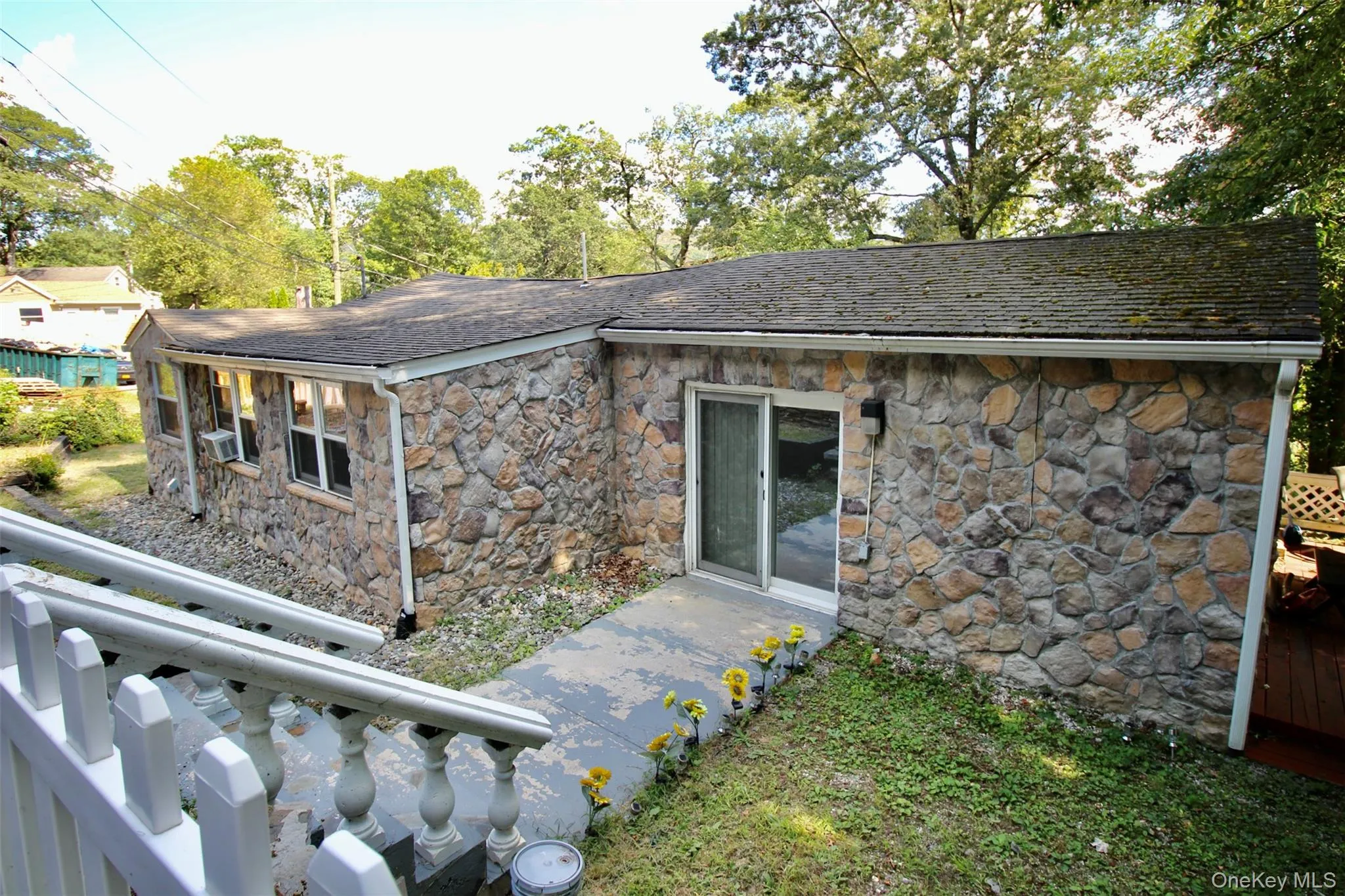 Rear view of property with stone siding Rear view of property with stone siding