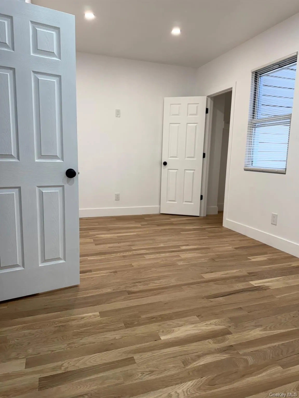 Empty room featuring wood finished floors and recessed lighting Empty room featuring wood finished floors and recessed lighting