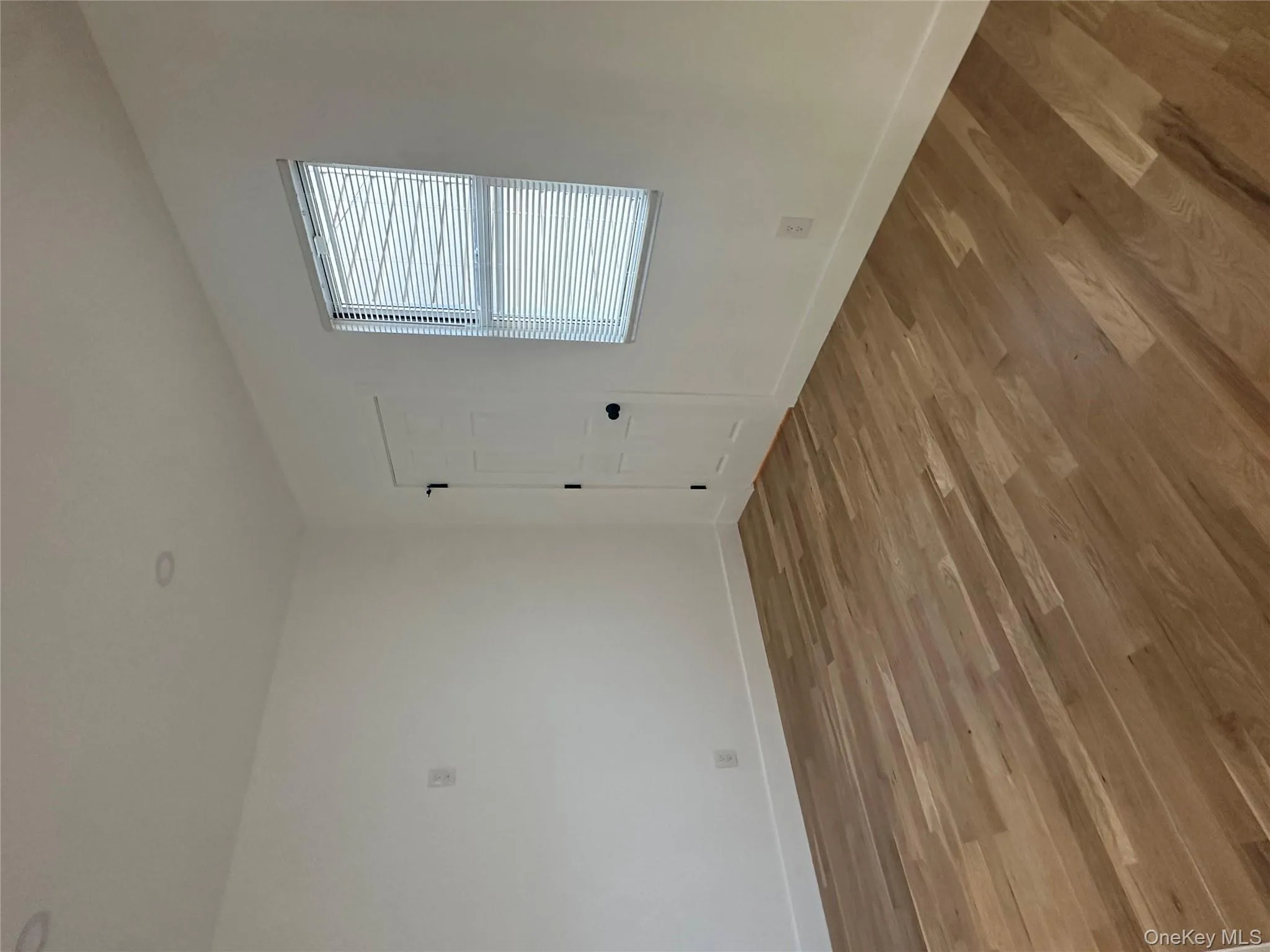 Spare room featuring wood finished floors and baseboards Spare room featuring wood finished floors and baseboards