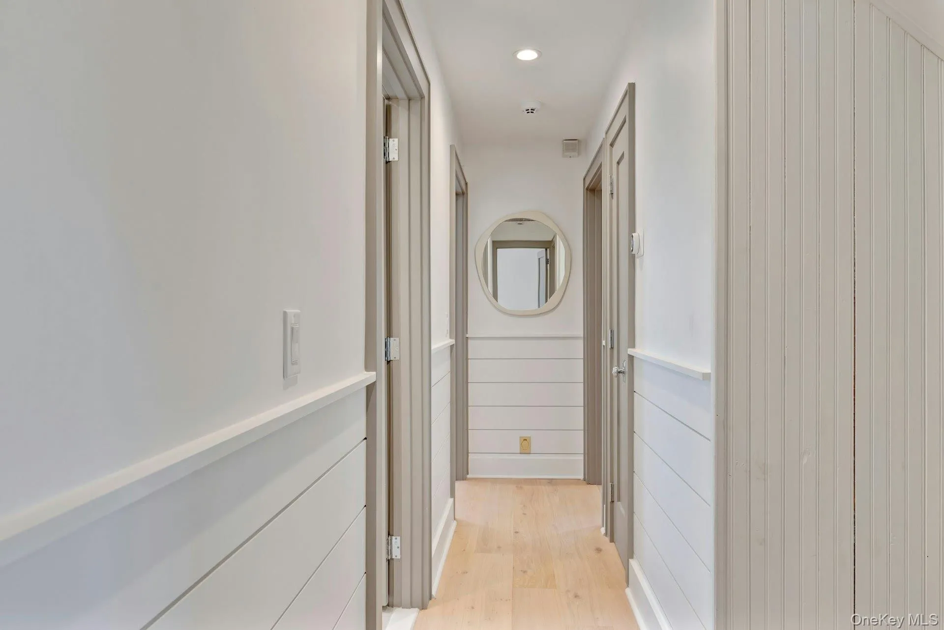 Corridor featuring recessed lighting and light wood-style flooring Corridor featuring recessed lighting and light wood-style flooring