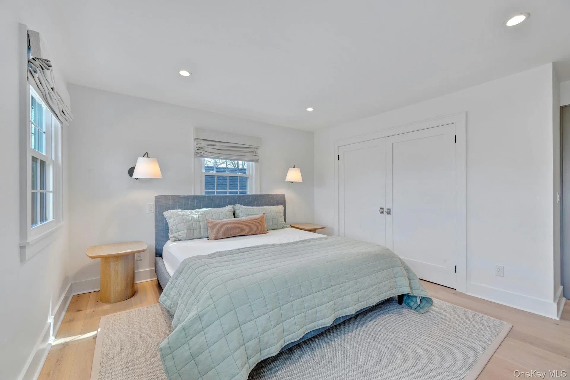 Bedroom featuring light wood-type flooring, recessed lighting, and a closet Bedroom featuring light wood-type flooring, recessed lighting, and a closet