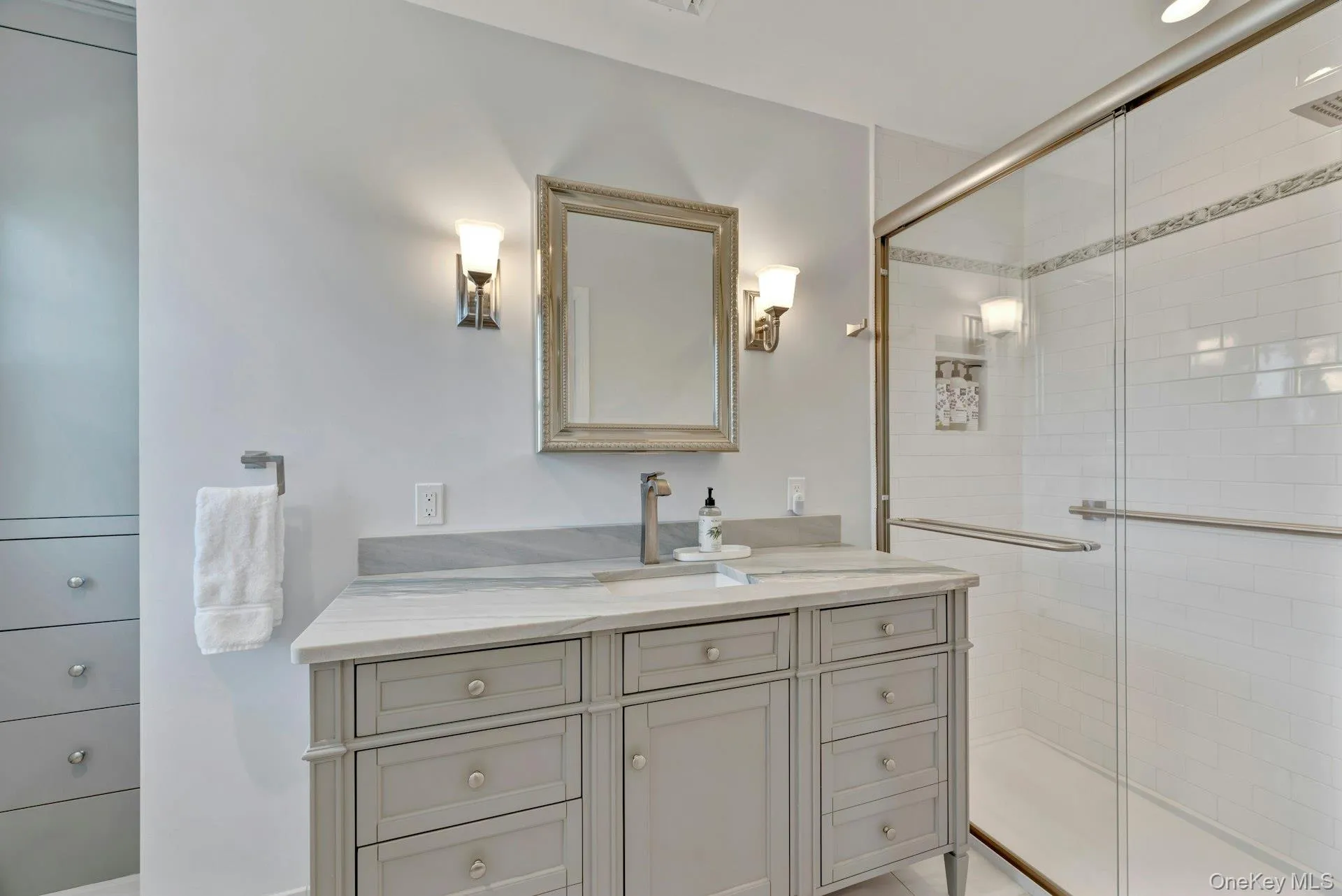 Bathroom with vanity and a shower stall Bathroom with vanity and a shower stall