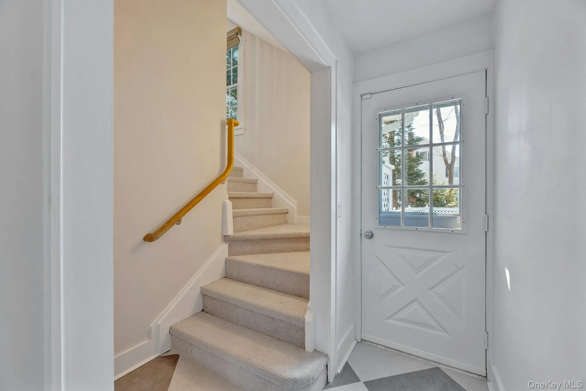 Entrance foyer featuring plenty of natural light, stairway, and light floors Entrance foyer featuring plenty of natural light, stairway, and light floors