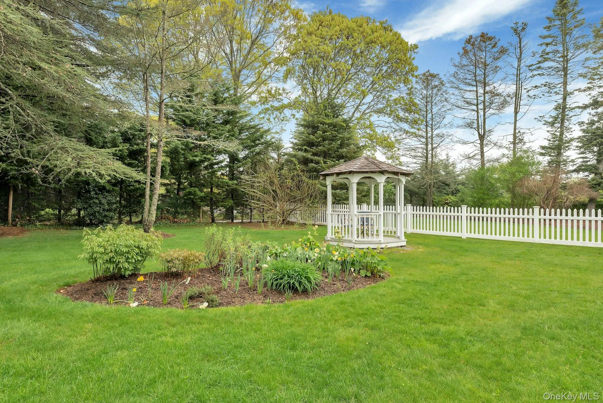 View of yard featuring a gazebo and view of wooded area View of yard featuring a gazebo and view of wooded area