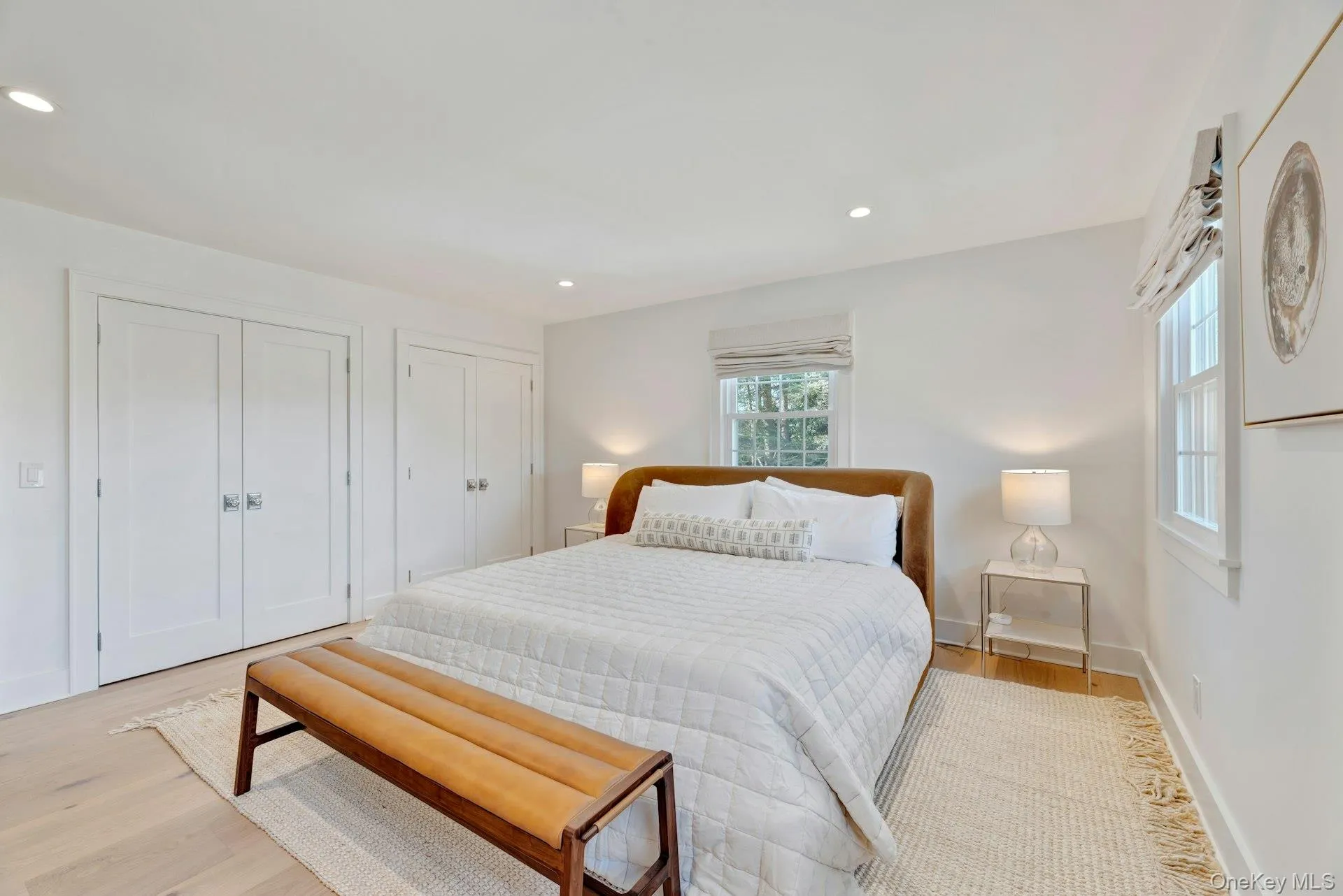 Bedroom featuring two closets, light wood-style floors, and recessed lighting Bedroom featuring two closets, light wood-style floors, and recessed lighting