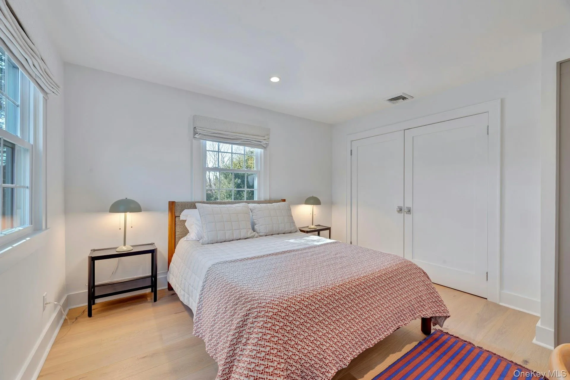 Bedroom featuring light wood finished floors, a closet, and recessed lighting Bedroom featuring light wood finished floors, a closet, and recessed lighting