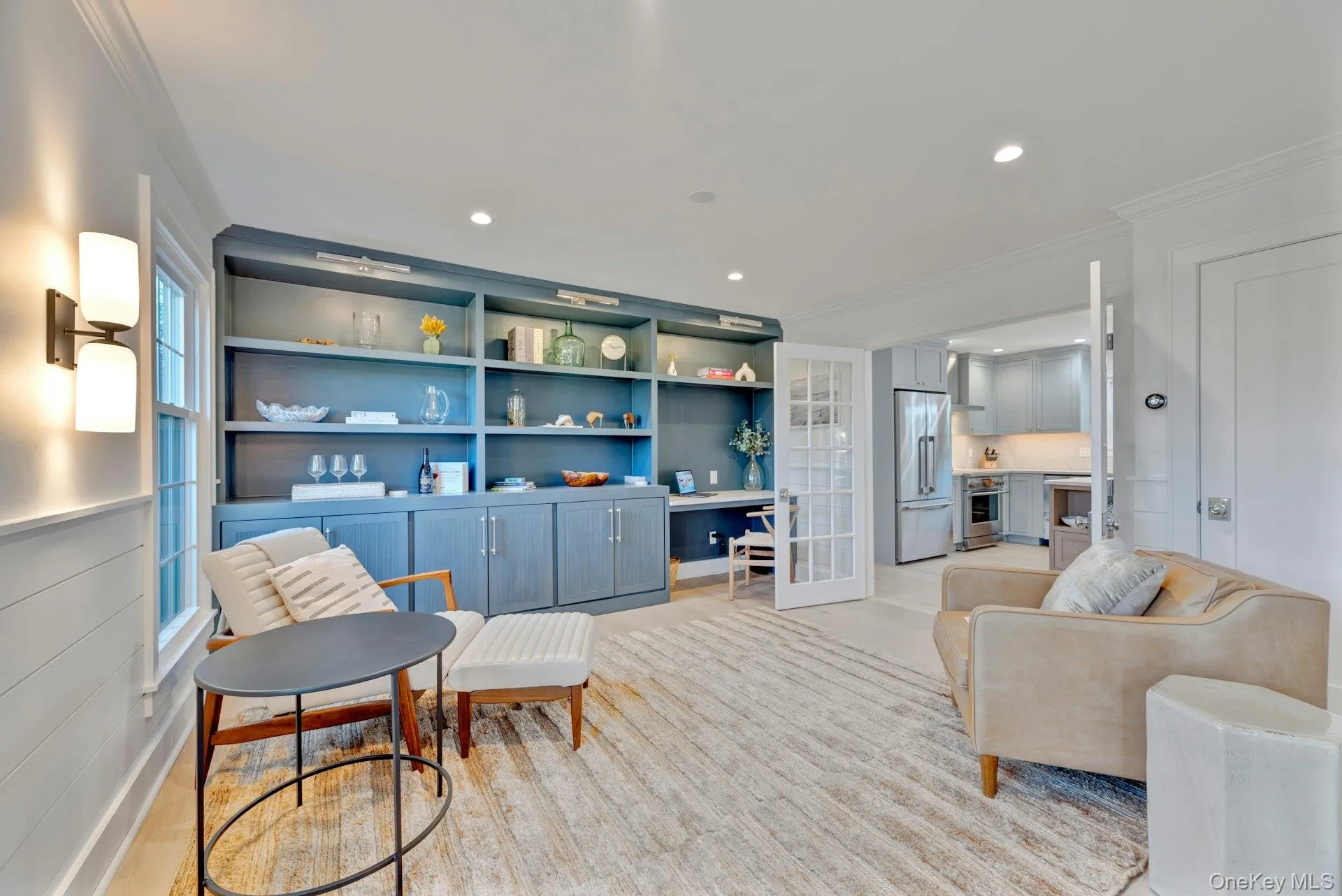 Living area with crown molding, french doors, built in desk, built in features, and recessed lighting Living area with crown molding, french doors, built in desk, built in features, and recessed lighting