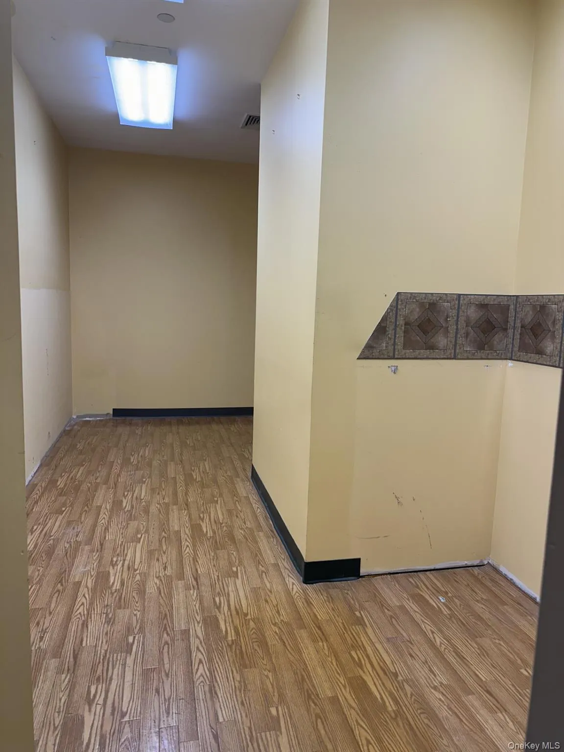 Spare room featuring light wood-style floors Spare room featuring light wood-style floors