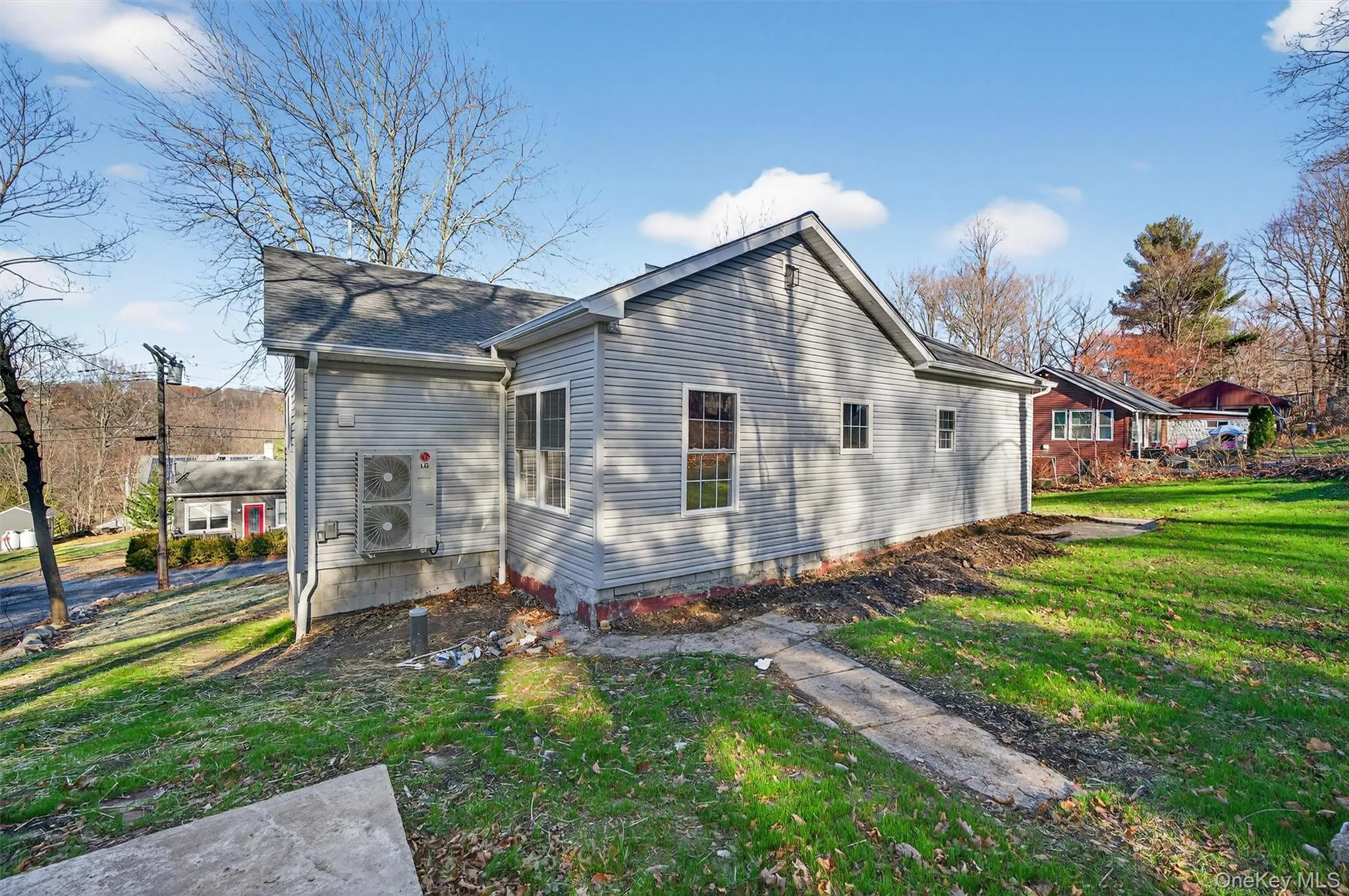Back of property featuring a yard Back of property featuring a yard