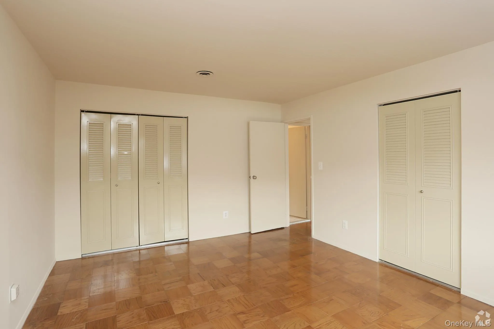 Unfurnished bedroom with two closets Unfurnished bedroom with two closets