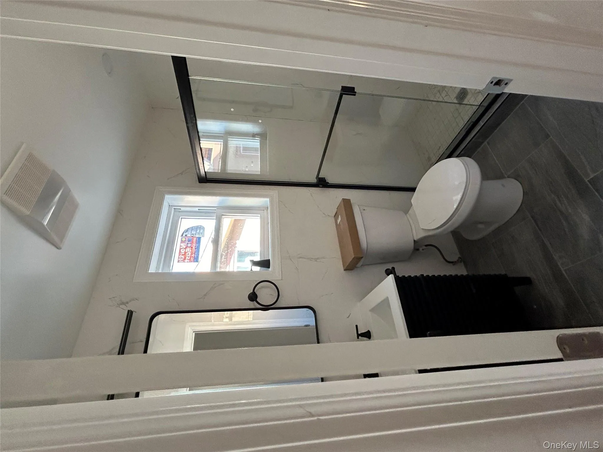 Bathroom with vanity and a marble finish shower Bathroom with vanity and a marble finish shower