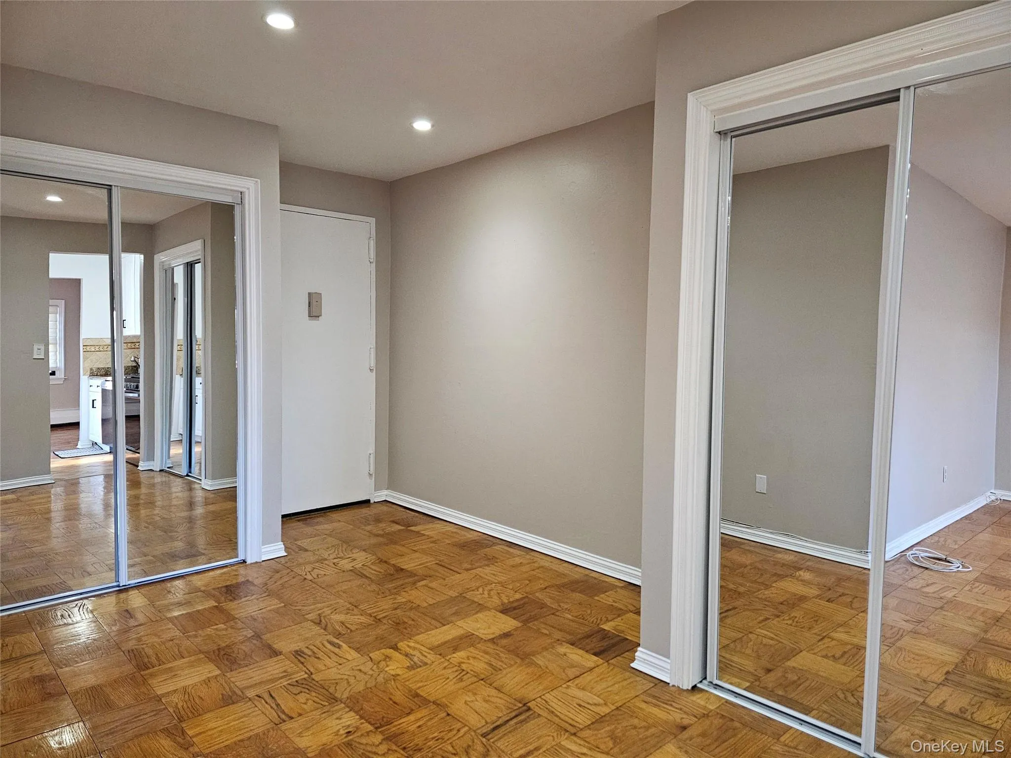 Unfurnished bedroom featuring recessed lighting and multiple closets Unfurnished bedroom featuring recessed lighting and multiple closets