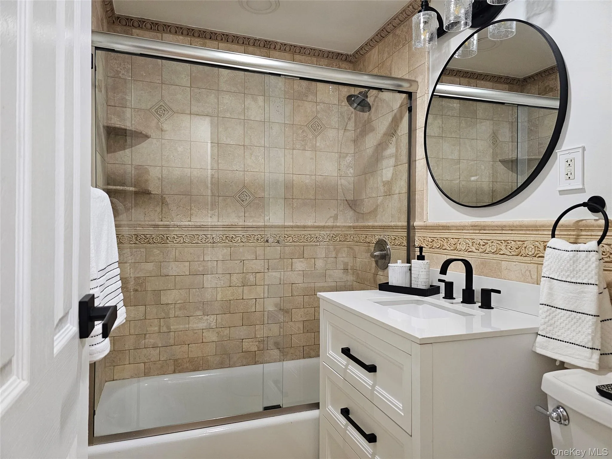 Full bathroom with vanity and enclosed tub / shower combo Full bathroom with vanity and enclosed tub / shower combo