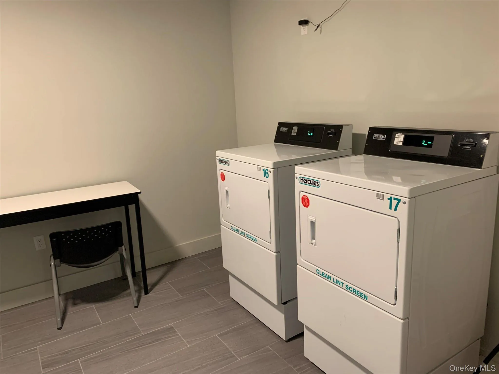 Community laundry room featuring separate washer and dryer Community laundry room featuring separate washer and dryer