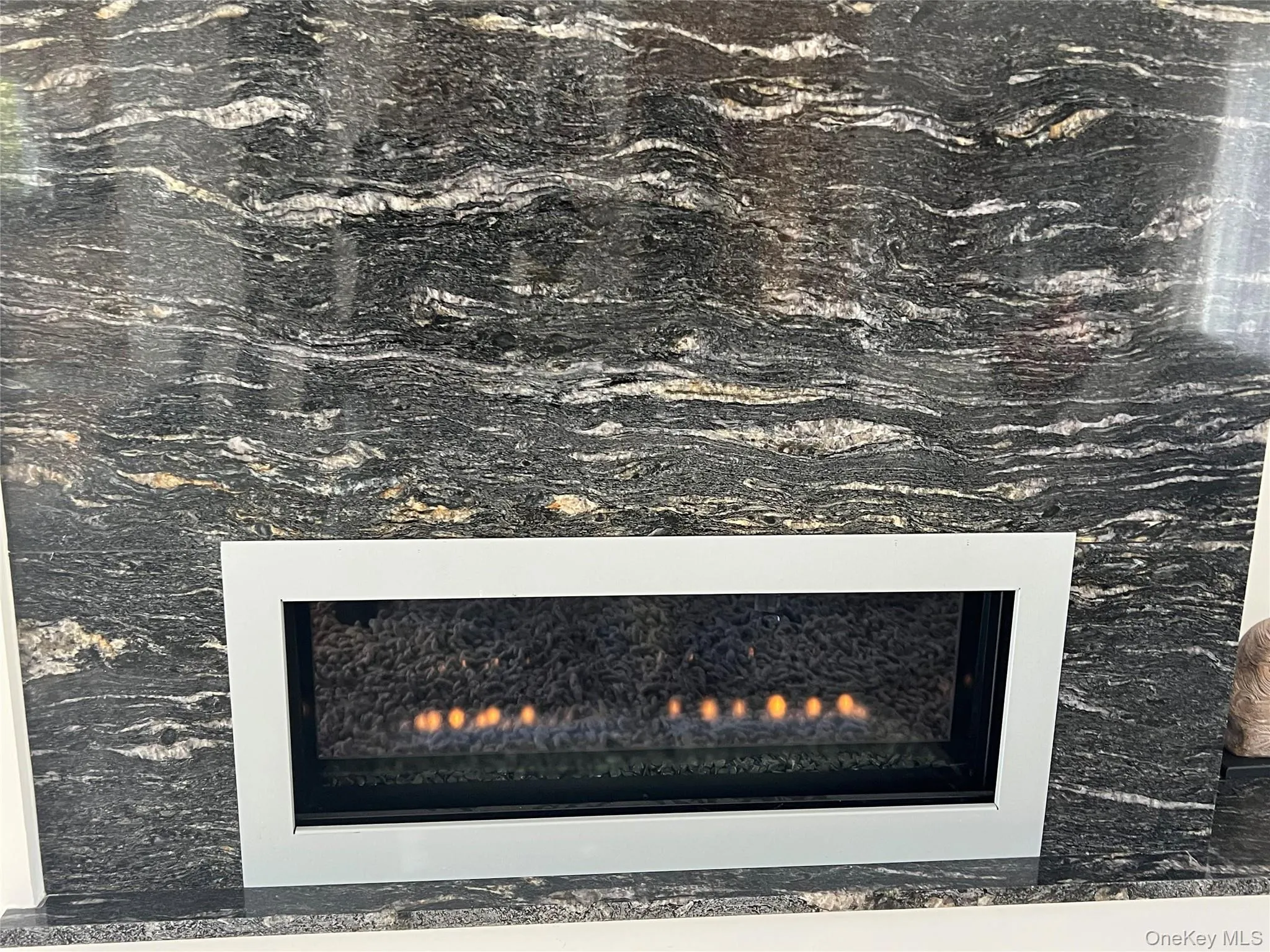 Detailed view of a warm lit gas fireplace Detailed view of a warm lit gas fireplace