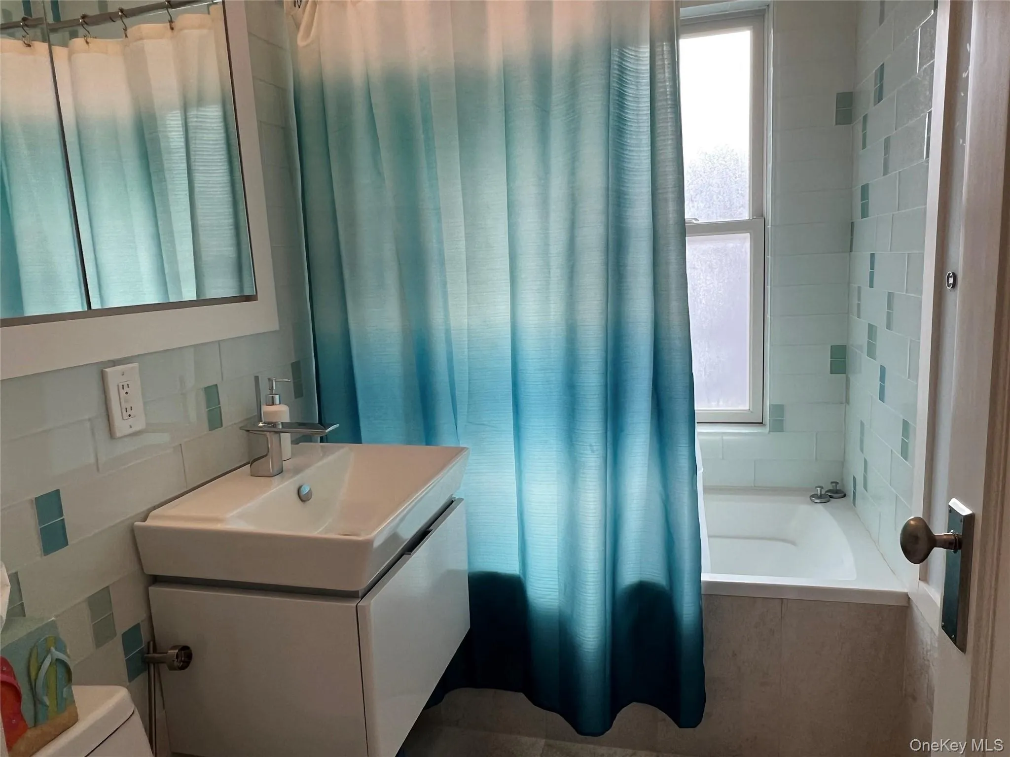 Full bathroom featuring tiled shower / bath and vanity Full bathroom featuring tiled shower / bath and vanity