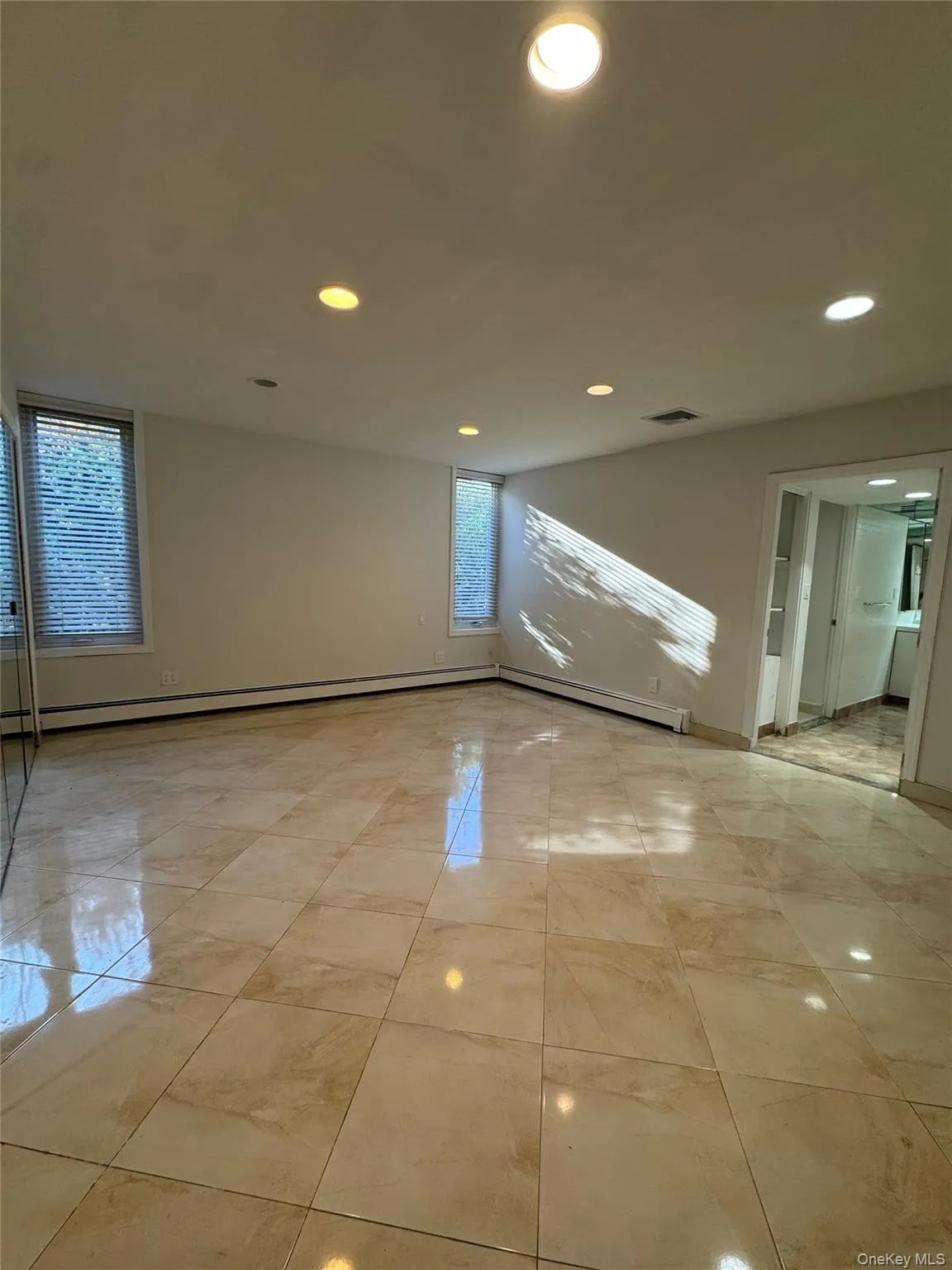 Unfurnished room with recessed lighting and a baseboard radiator Unfurnished room with recessed lighting and a baseboard radiator