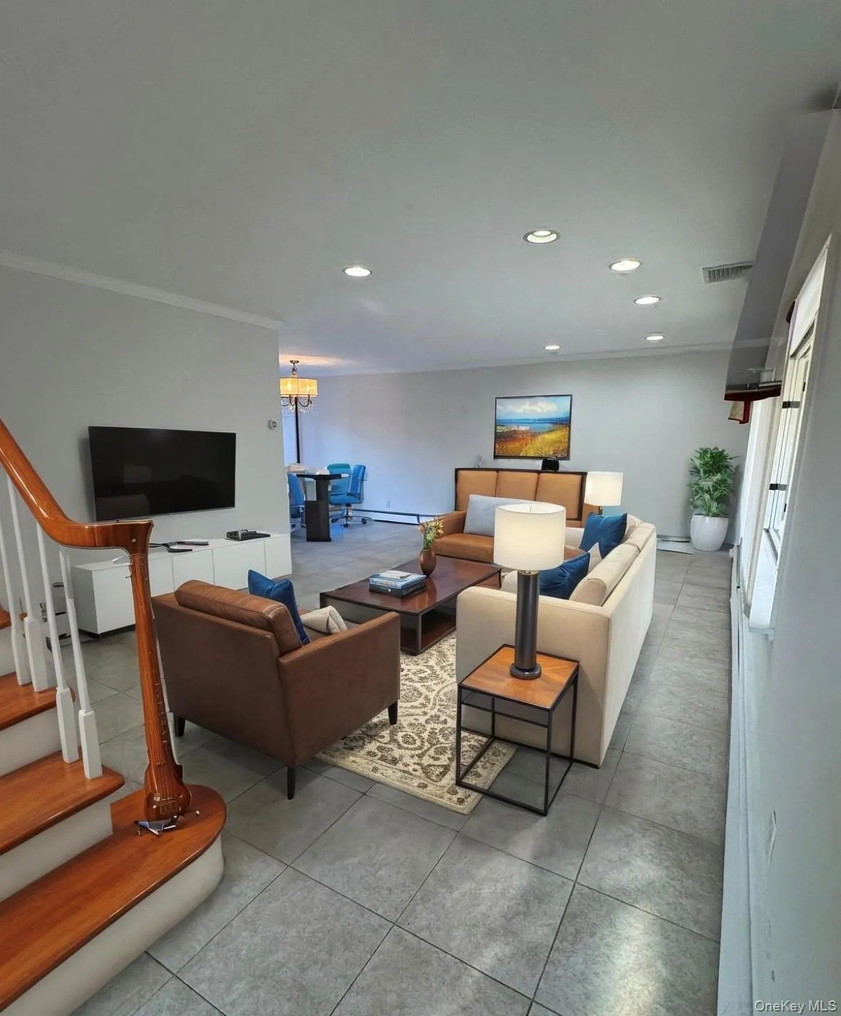 Tiled living room featuring ornamental molding, recessed lighting, and stairs Tiled living room featuring ornamental molding, recessed lighting, and stairs