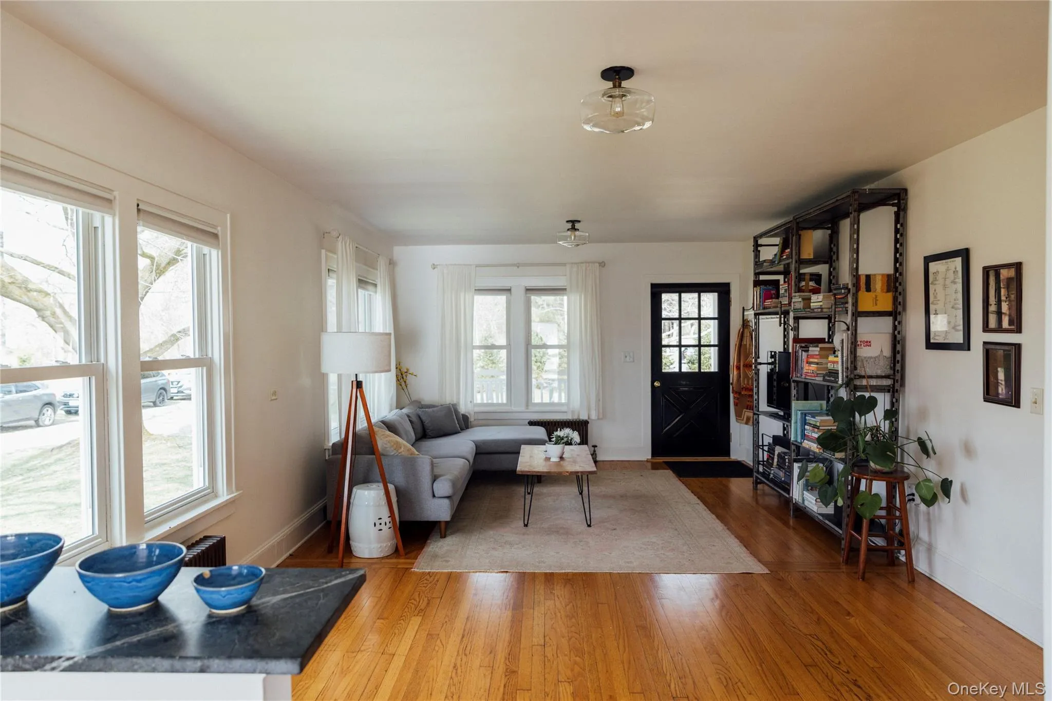 Living area featuring baseboards and light wood-style flooring Living area featuring baseboards and light wood-style flooring